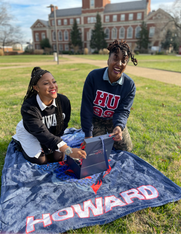 Two happy Black African American women on The Yard at Howard University opening the Capstone Crate Subscription Box